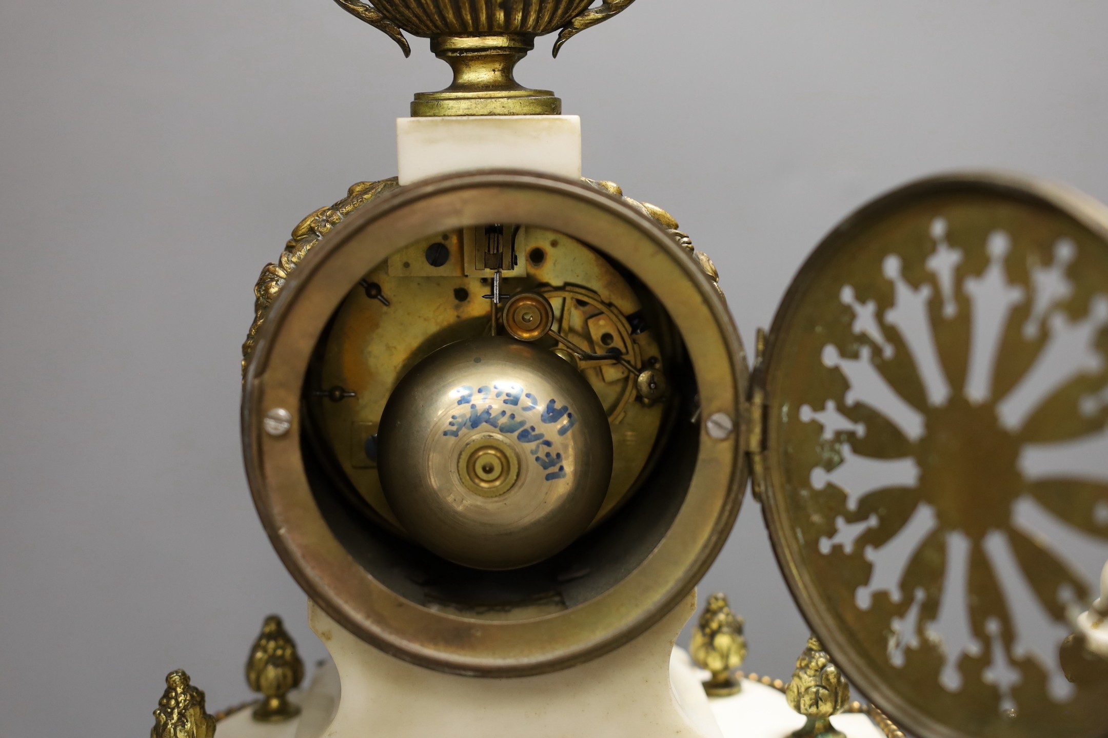 A Louis XVI style white marble and ormolu clock garniture, clock 47cms high